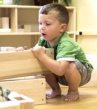 a boy stacking hollow blocks