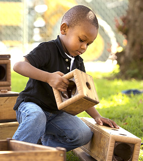 a boy playing with outlast blocks