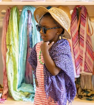 a child wearing a hat and a scarf