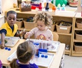 three children in a classroom 