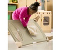 A child is storing her bedding under her cot