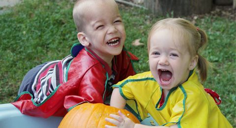 two children with a pumpkin