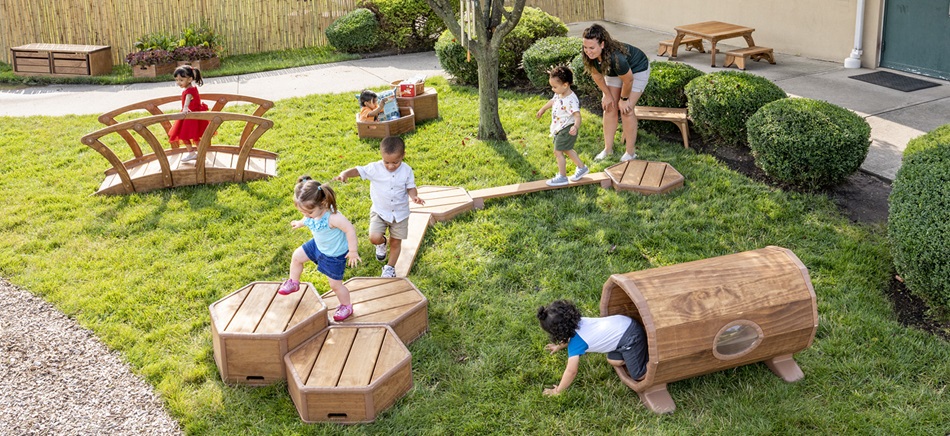 kids playing on toddler climbing toys outdoors