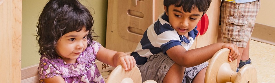 two children playing in a classroom