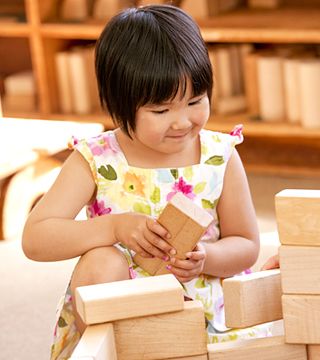 a girl stacking blocks